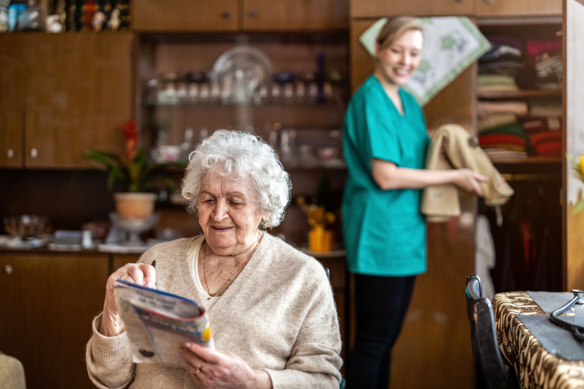 Female nurse taking care of a senior woman at home