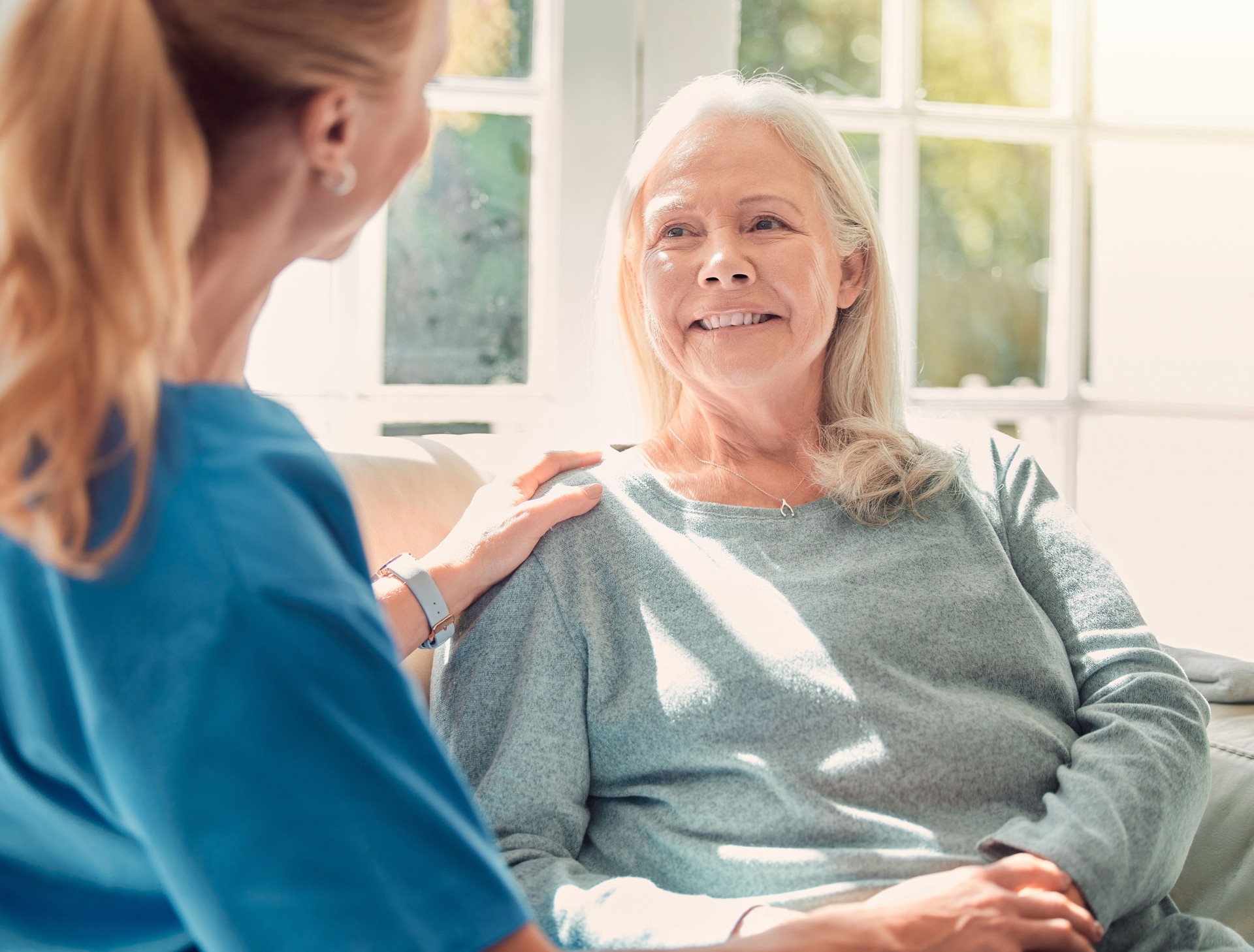 Shot of a senior woman being supported by her nurse at home